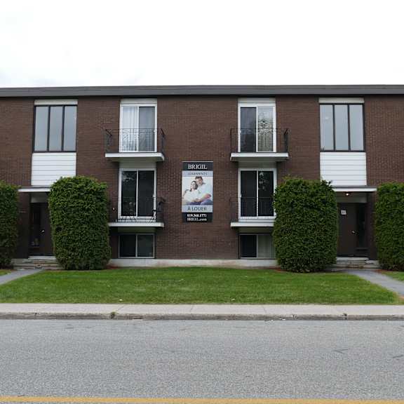 apartment building with a sign that says "sunset park apartments".