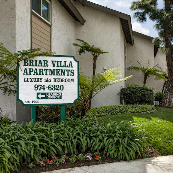 a sign for briar villa apartments is in front of a building.