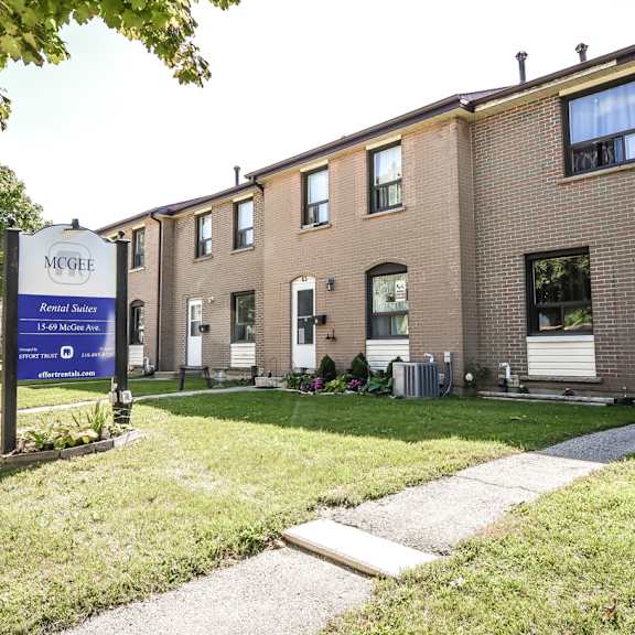 a mcgehee senior living community with a blue sign in front of the building.
