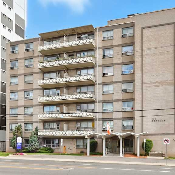 a large apartment building with a balcony on the second floor.