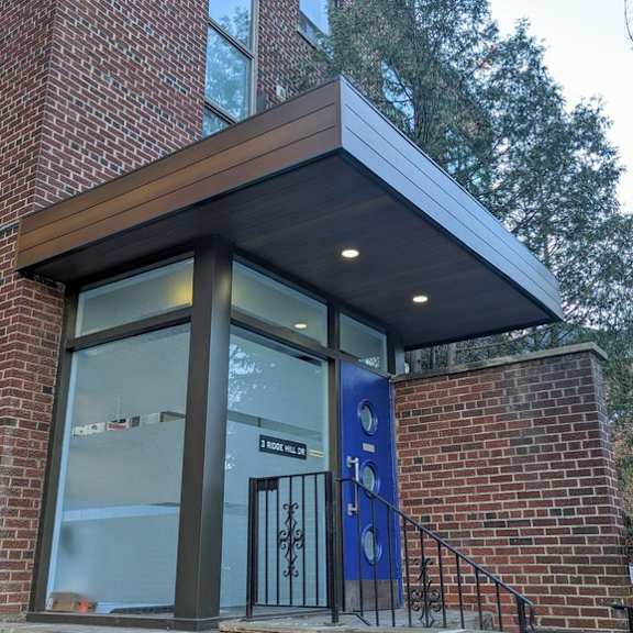 a building with a blue door and a sign that says "1000 n. 10th ave."