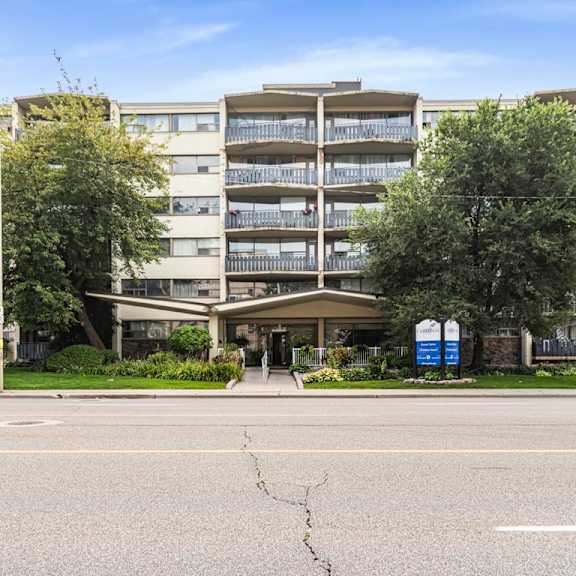 a large apartment complex with a crack in the road in front.