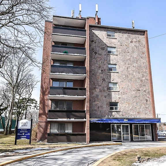 a tall brick building with a blue awning and a sign that reads "fanny's".