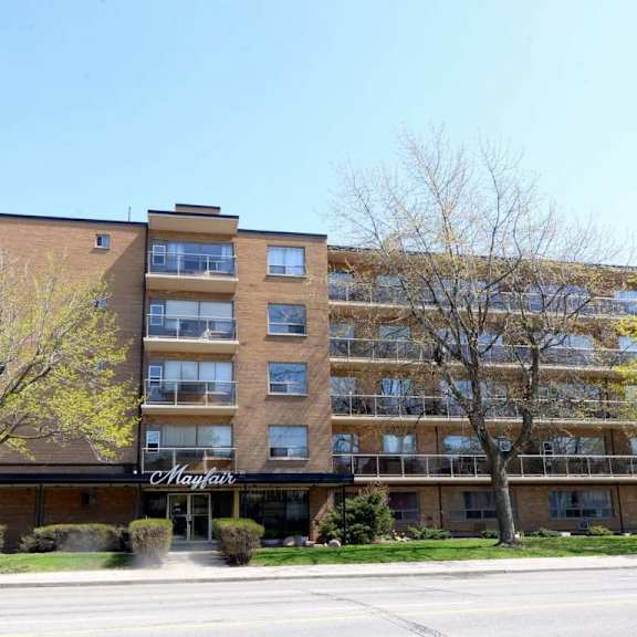 a large apartment building with the name "maple" on the front.