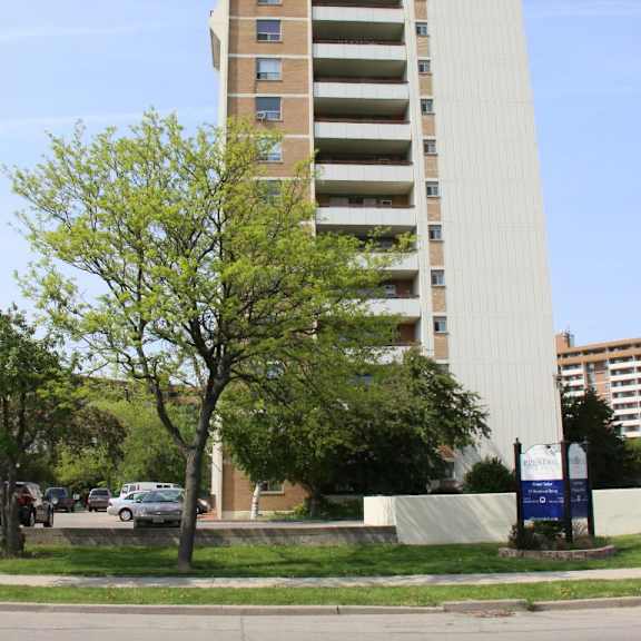 a tall building with a tree in front of it.