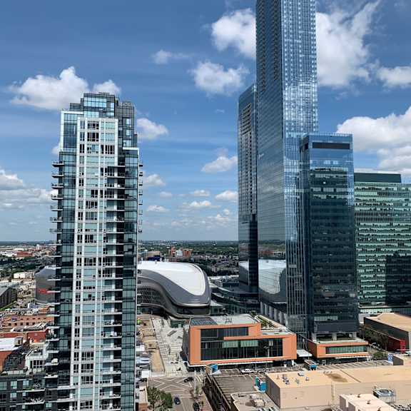 two modern glass buildings in a city.