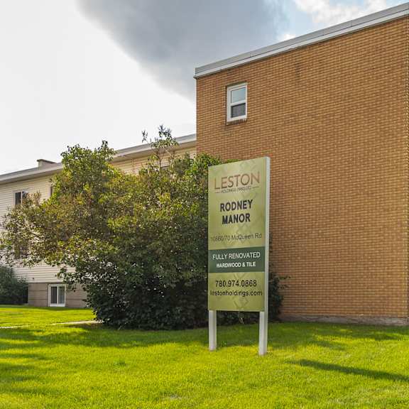 a sign for leston nursing home stands in front of a building.