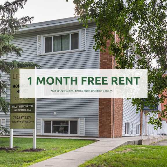 a sign offering a free one month rent is displayed in front of a building.