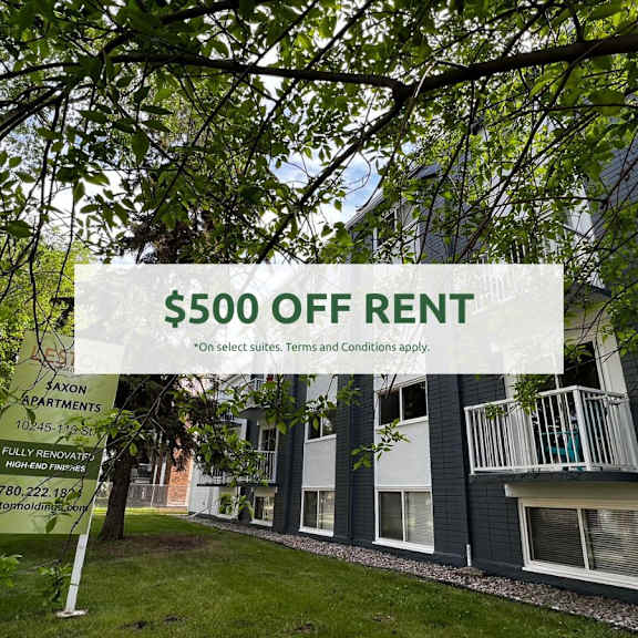 a sign advertising $500 off rent in front of a building.