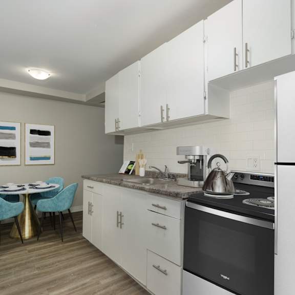 a kitchen with a table and chairs and a fridge.