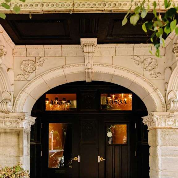 a building with a black door and a sign that reads 1653a.