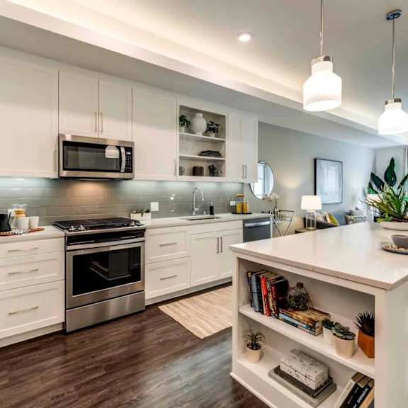 a modern kitchen with white cabinets and a central island.