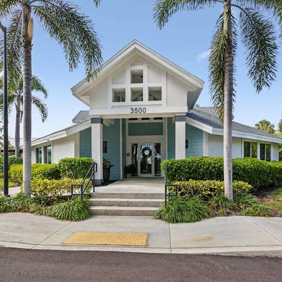 the front of a house with palm trees at the villages of banyan grove, florida, 33436