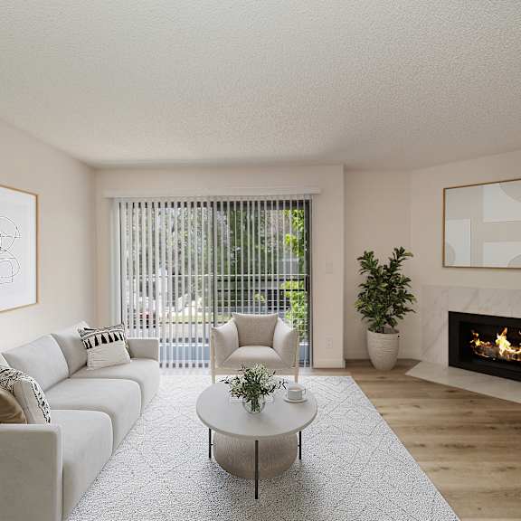 a living room with a white couch and coffee table in front of a fireplace at croft plaza apartments, west hollywood