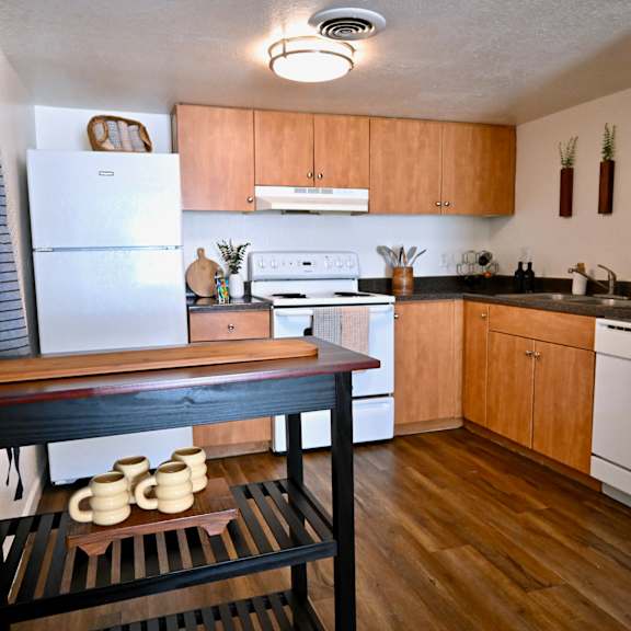 a kitchen with wooden cabinets and a white refrigerator.