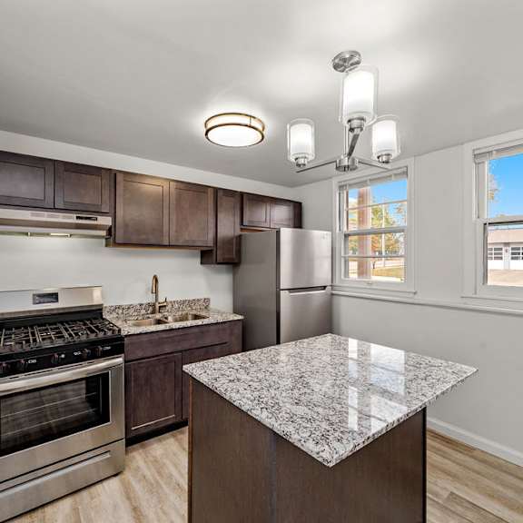 a kitchen with a granite counter top and stainless steel appliances.