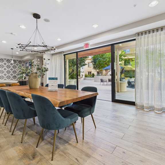 a dining room with a long table and chairs.