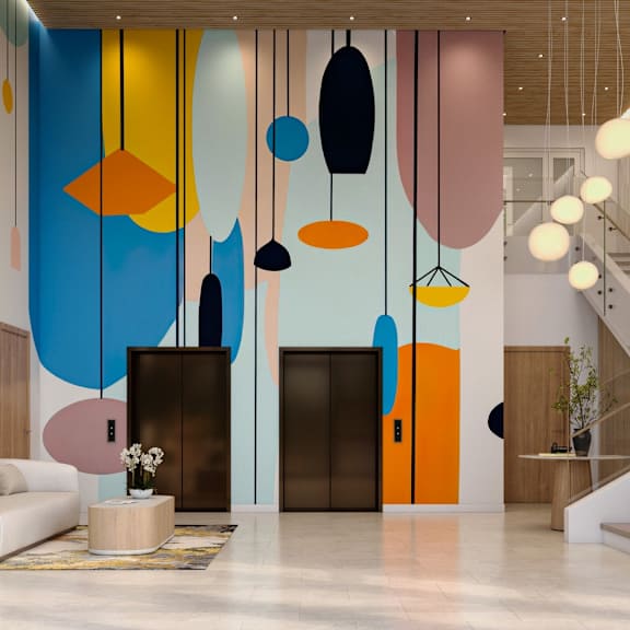 a modern interior with a staircase, a sofa, a table, and a large painting on the wall.