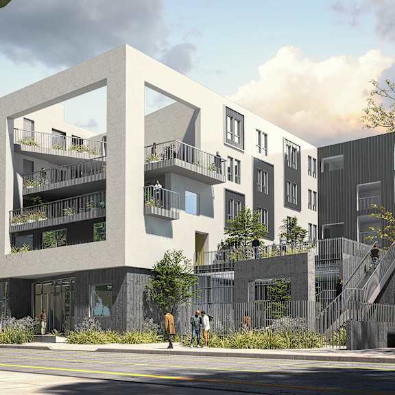 a modern building with balconies and a car parked in front.