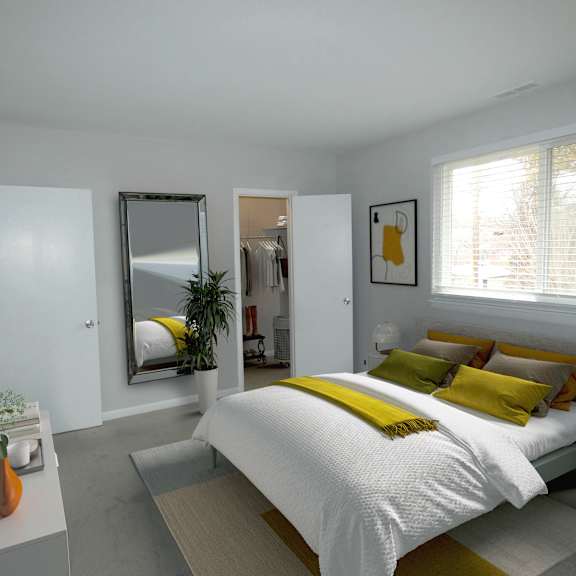 a bedroom with white walls and a yellow and white bedspread