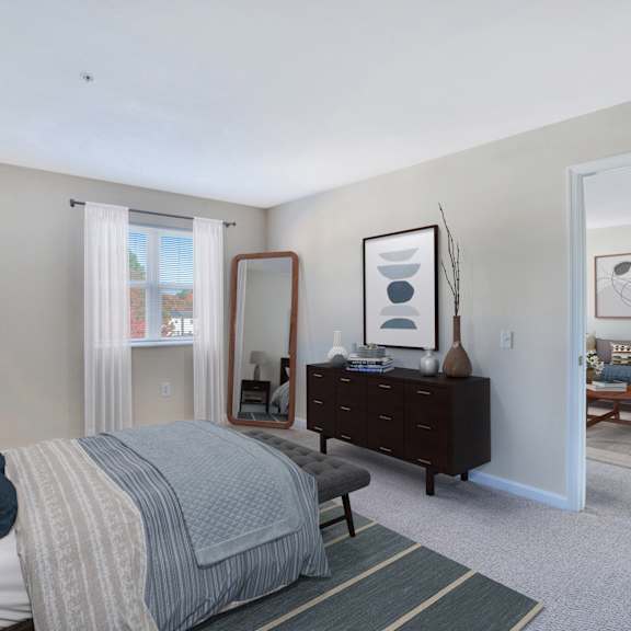 a bedroom with a bed and a dresser and a mirror