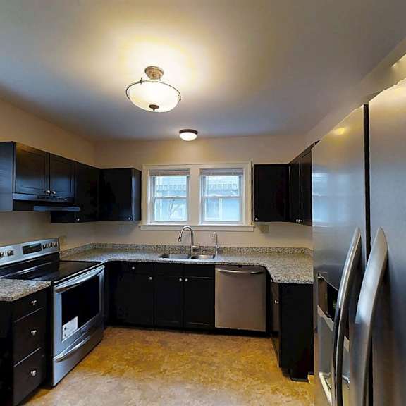 a kitchen with black appliances and cabinets.
