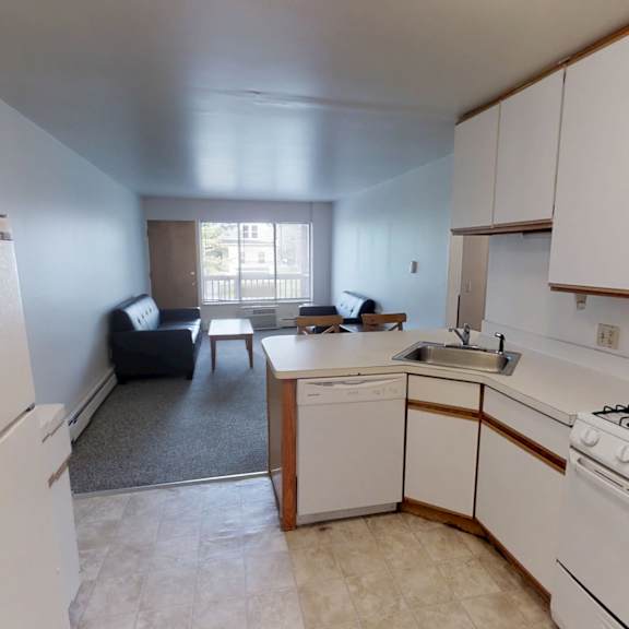 a kitchen with white appliances and cabinets.