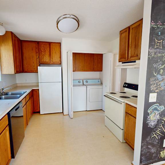 a kitchen with wooden cabinets and a mural on the wall.