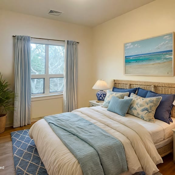 a bedroom with a large bed and a painting of a beach on the wall.