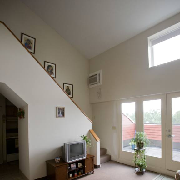 a living room with a tv and a staircase