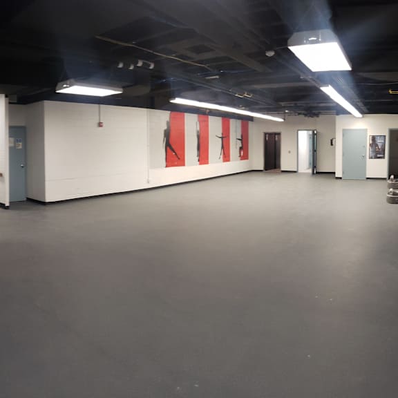 a long hallway with a red flag on the wall.