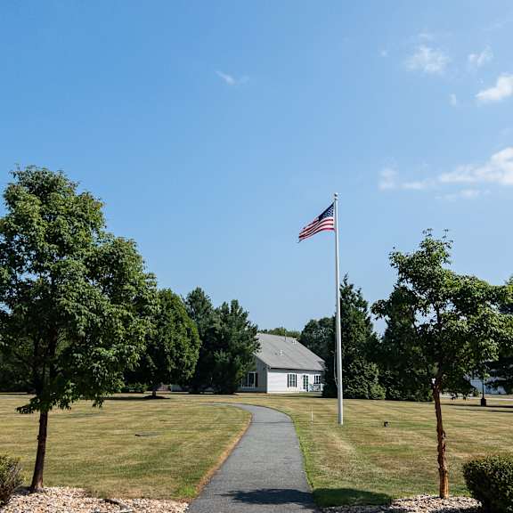 a flag is flying in front of a house.
