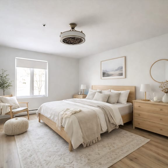 a bedroom with a large bed, a chair, and a plant.