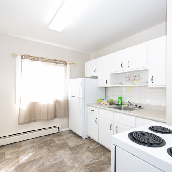 a kitchen with white appliances and cabinets.