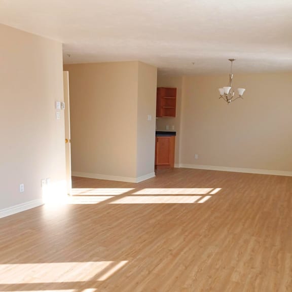 a room with wooden floors and a chandelier.