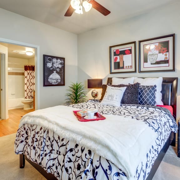 a bedroom with a large bed and a ceiling fan