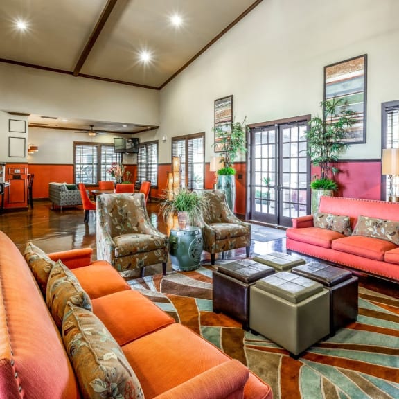 a living room with couches and chairs and a kitchen