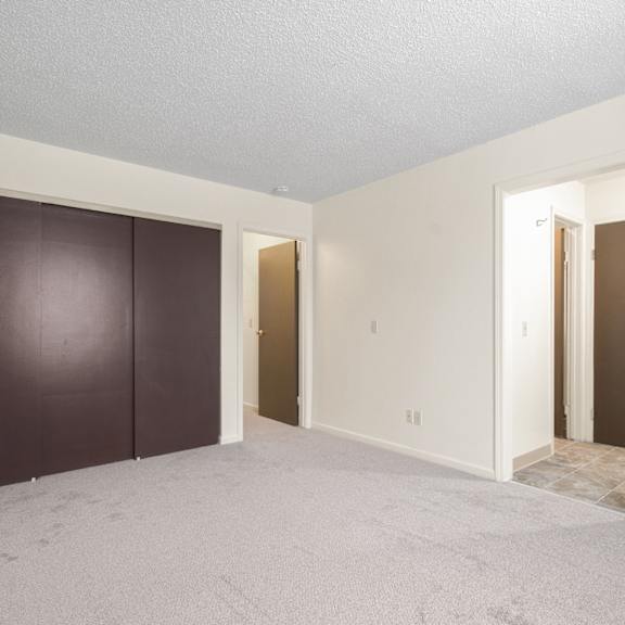 a room with a brown door and a white door.