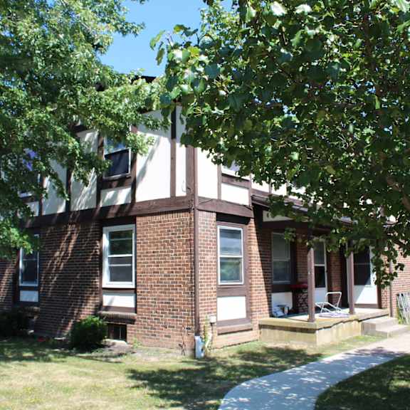 a house with a brown brick exterior and a white window.