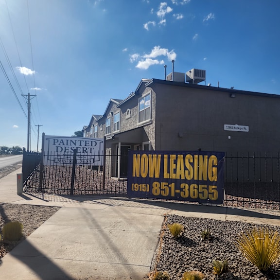 a building with a sign that reads now leasing