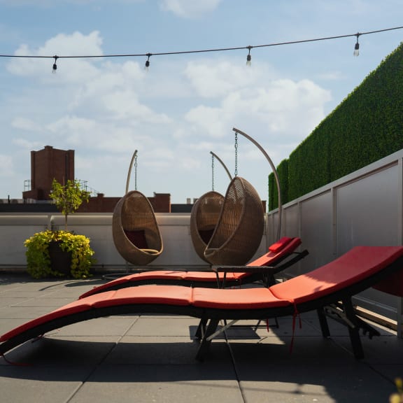 a red lounge bench on a roof top patio at 34 Berry, Brooklyn, New York