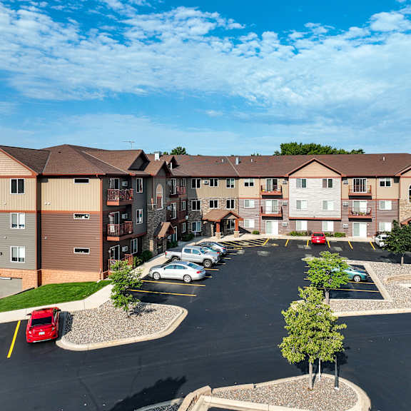 an aerial view of an apartment building in a parking lot