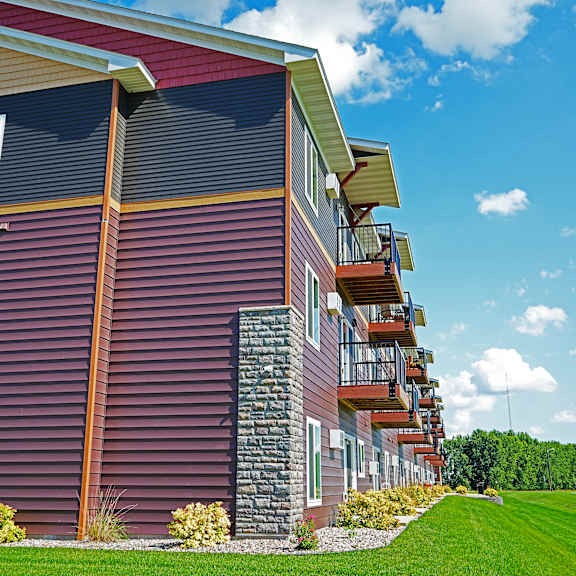 a red building with a balcony on the second floor.