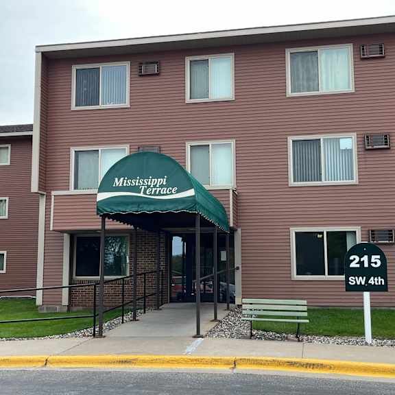 the front of the mississippi terrace apartment building with a green awning.