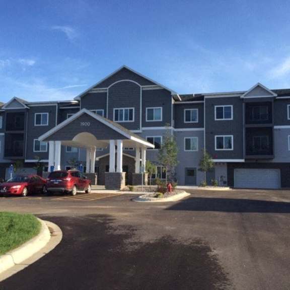 an apartment building with cars parked in front of it