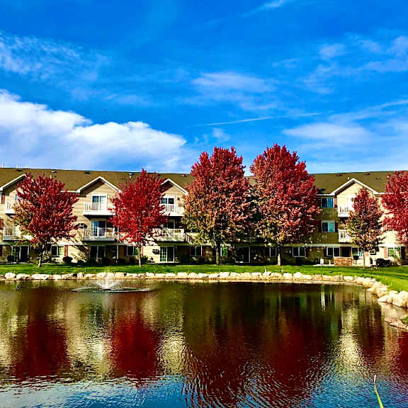 a row of houses with trees in front of them.