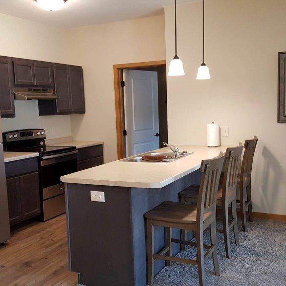 a kitchen with a refrigerator, stove, and oven.