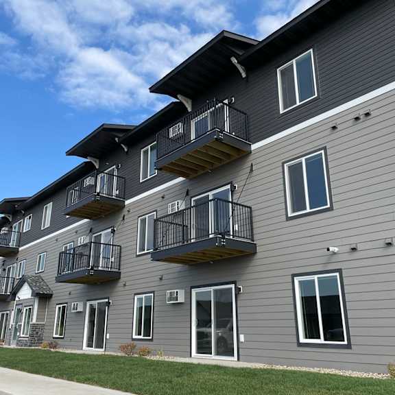 the exterior of an apartment building with balconies