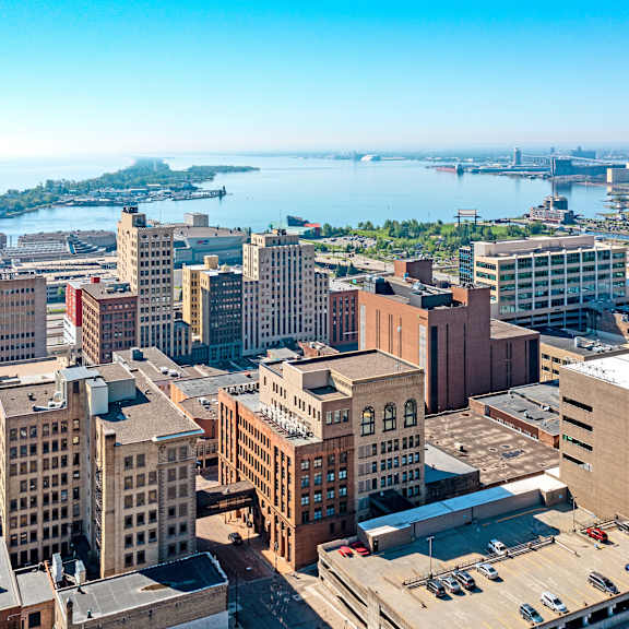 an aerial view of the city with the water in the background