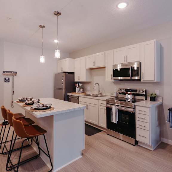 a kitchen with white cabinets and a white counter top and a black and white